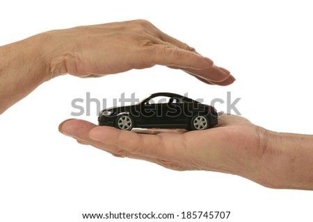 Businessman with miniature car isolated on white background