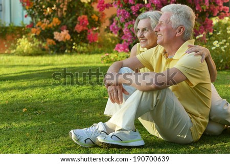 Senior couple sitting at tropic hotel garden on vacations