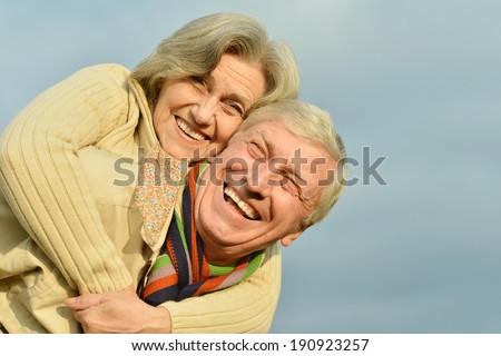 Portrait of a happy old couple at sky