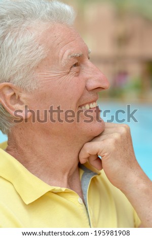 Thinking smiling senior man at the resort