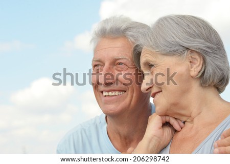 Happy senior couple on a sky background