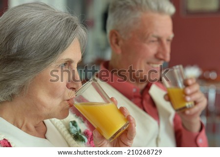 Portrait of beautiful elderly couple drinking juice