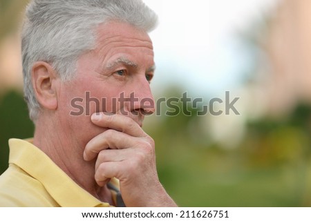 Close-up portrait of a senior man thinking about something