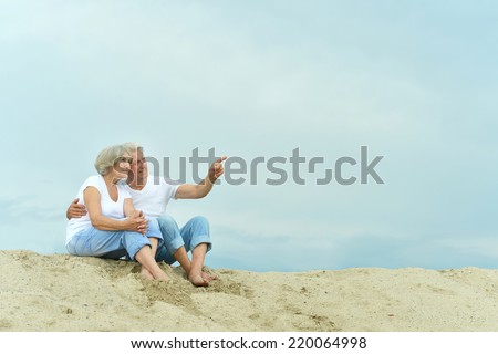 Amusing  happy elderly couple on the beach