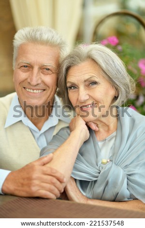 Happy beautiful older couple drink coffee together