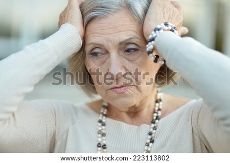 Portrait of a sad elderly thinking woman