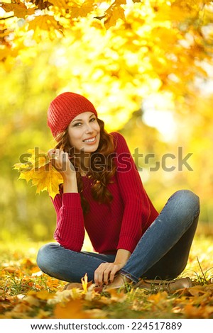 beautiful young woman on walk in autumn park