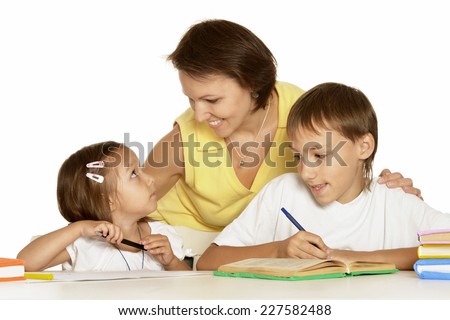 Parents help children do their homework at table