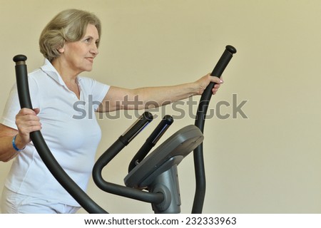 Portrait of elderly woman exercising in gym