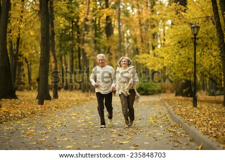 Mature couple walking in the autumn park
