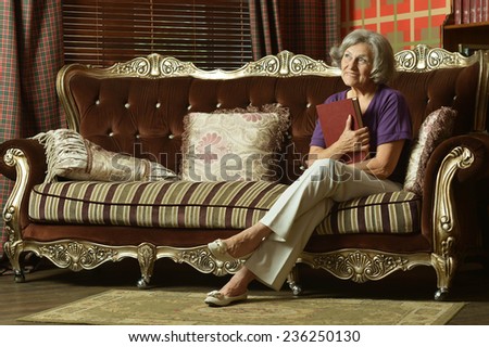 Relaxed grandmother sitting on the couch at home