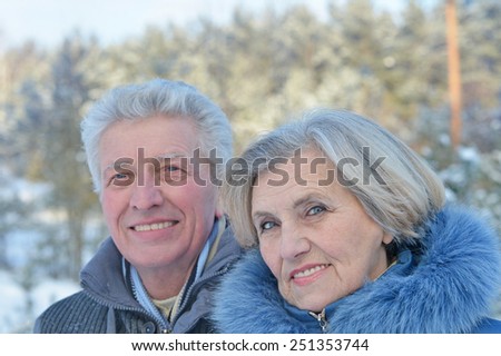 Happy senior couple walking in winter outdoors