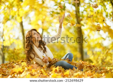 beautiful young woman on walk in autumn park