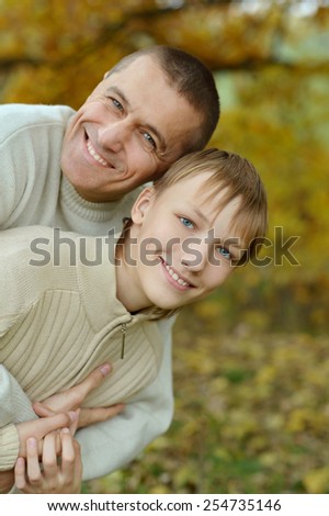 Portrait of father and son in autumn park
