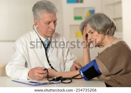 Senior woman visiting doctor at hospital