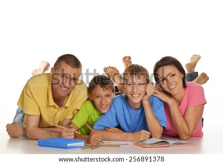 Parents help children do their homework on the floor