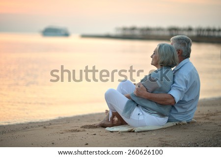 Portrait of a senior couple at sea at sunset