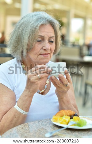 Portrait of beautiful elderly woman in cafe