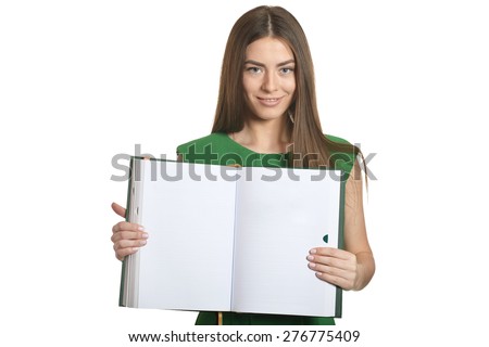 Beautiful woman in green dress with book on white background
