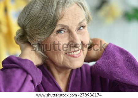 Close-up portrait of a happy older woman at home