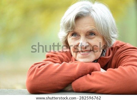 portrait of a happy old woman posing at nature