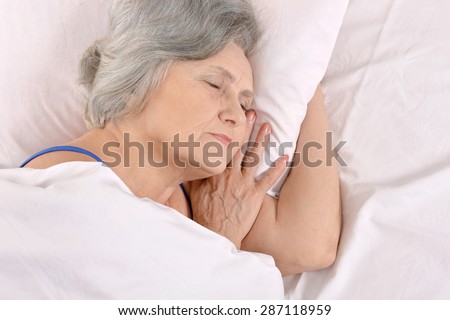 Beautiful older woman sleeping in the bedroom