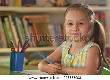 Portrait of Little girl drawing at home