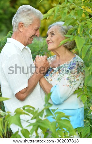 Loving mature couple on a walk in the park in summer