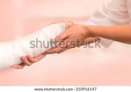Female Doctor and young boy with a broken arm