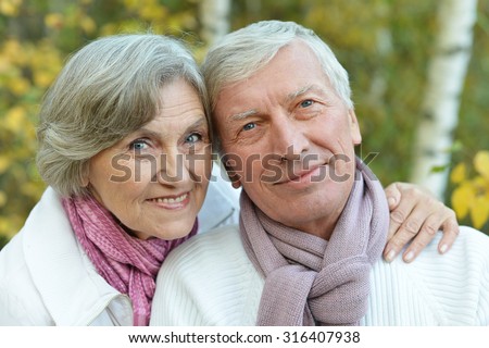 Happy senior couple in autumn park close-up