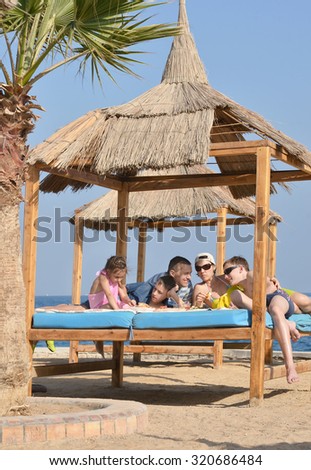 Happy family having lunch on a beach