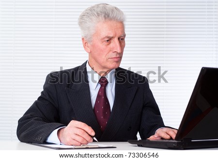 senior businessman with laptop on white background