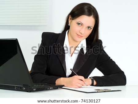 nice girl in a business suit working in the office