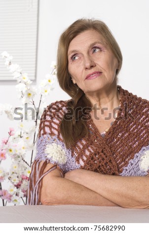 beautiful elderly woman in  brown clothes on white background