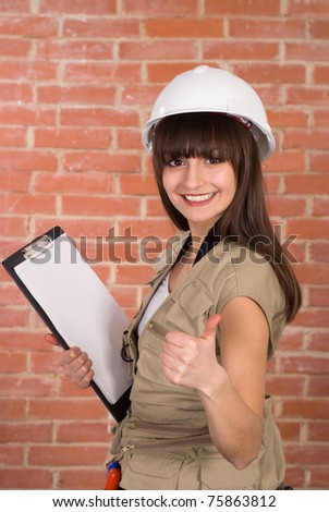 pretty young worker  in a white helmet