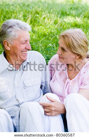happy old couple playing at the nature