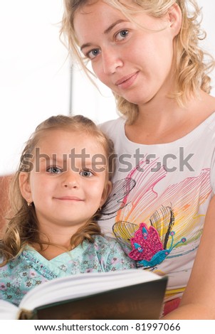 mom and her daughter read a book
