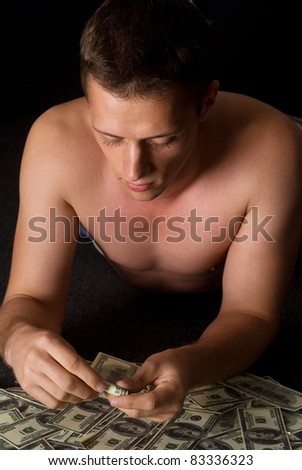 young pretty guy with cash on a black