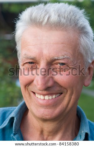 portrait of a cute aged man at nature
