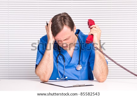 cute doctor with a telephone at table