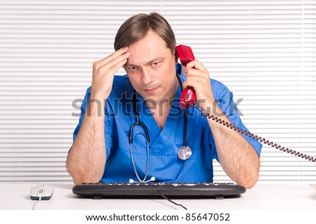 portrait of a cute doctor at computer
