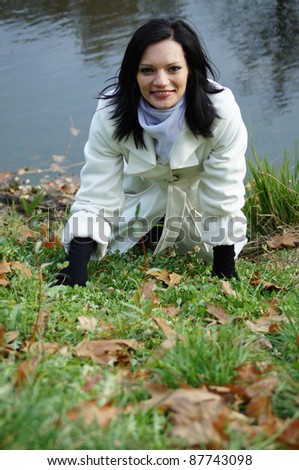 cute woman posing near the water in jacket