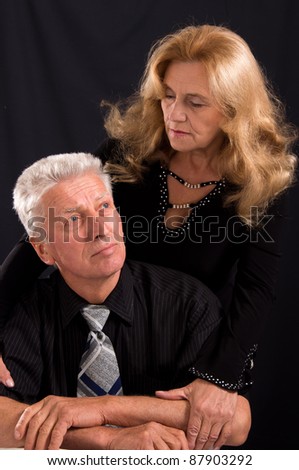 portrait of a cute old couple on a black
