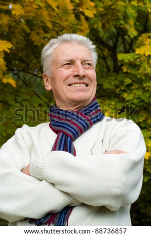 cute old man posing at autumn park