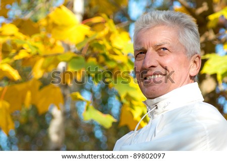 cute old guy posing at autumn park