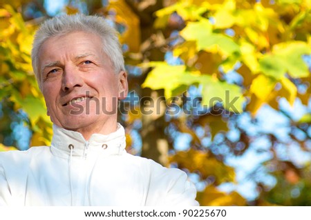 cute old guy posing at autumn park