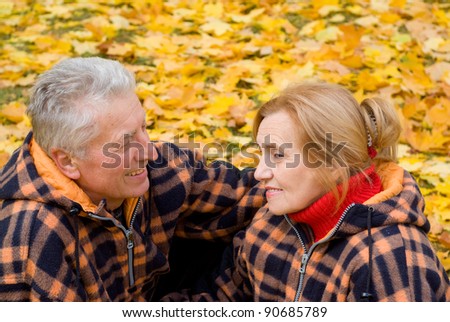 cute old couple posing in autumn park