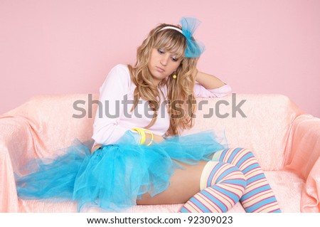 sweet girl in blue skirt on sofa