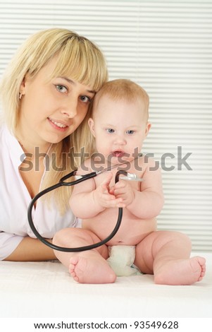 portrait of a cute doctor with baby