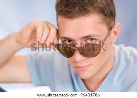 cool guy in blue tshirt with glasses
